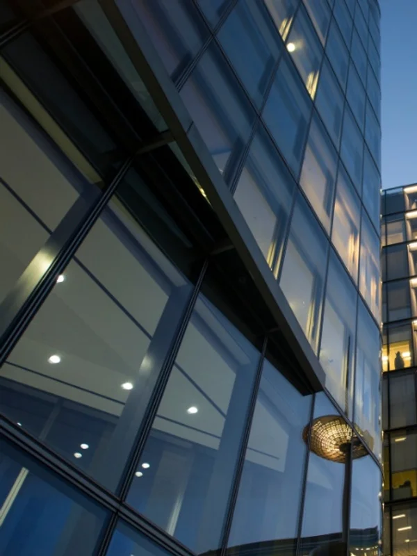 A glass office tower seen from below